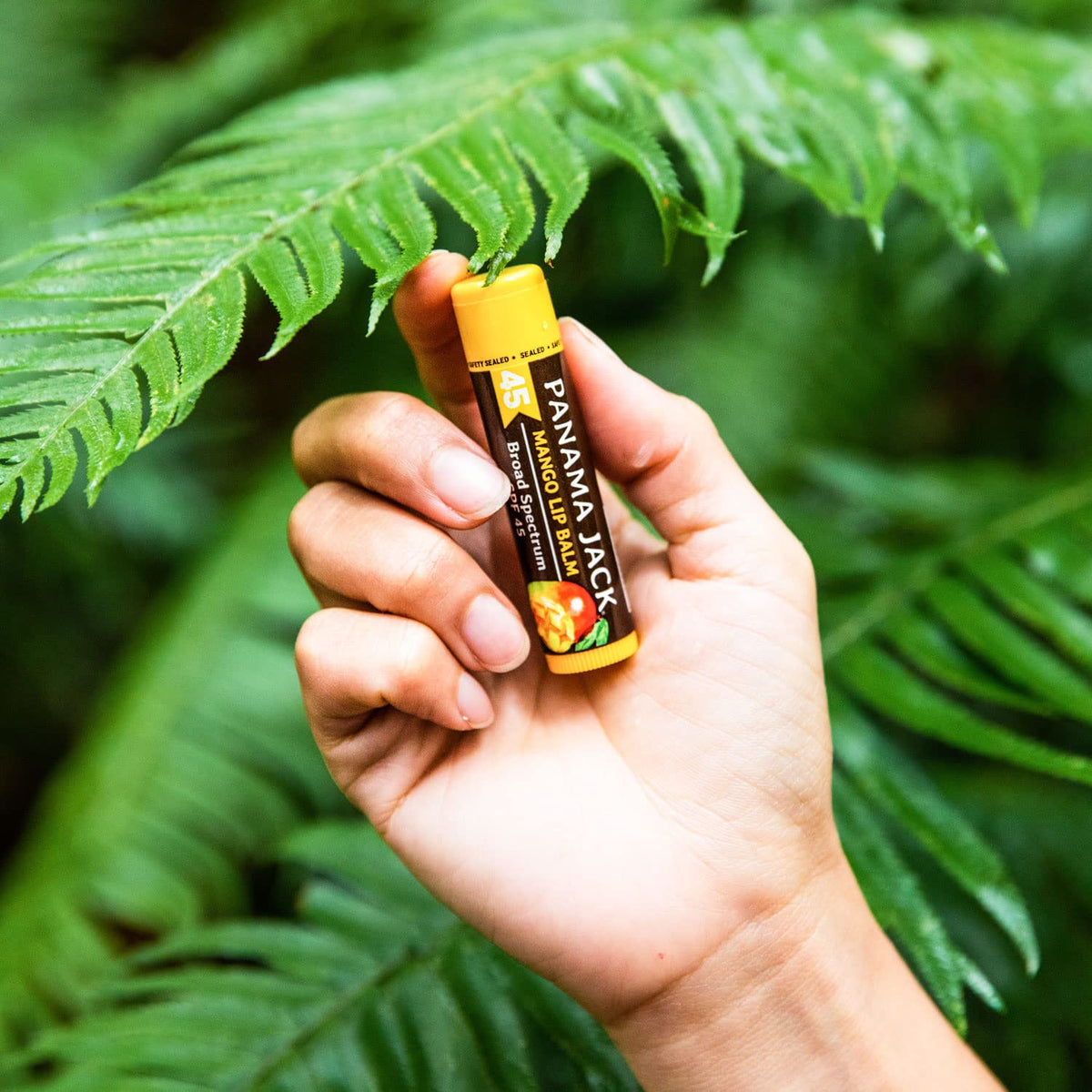 Panama Jack tube in hand showing compact size and travel-friendly benefit