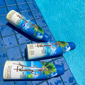 Panama Jack bottle near water illustrating 80-minute water-resistant benefit