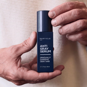 Particle serum massaged into scalp illustrating follicle-targeted delivery and comfort