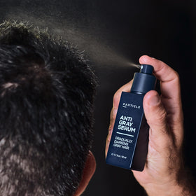 Particle serum next to ruler for size comparison indicating travel-friendly bottle