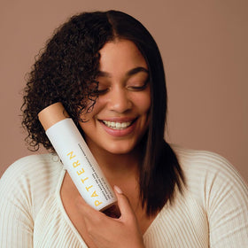PATTERN hands applying pre-poo to damp hair for easier detangling