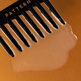 PATTERN applied to wet curly hair demonstrating easier detangling and reduced tugging