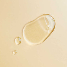 PATTERN single oil drop on finger highlighting lightweight texture for quick absorption and shine