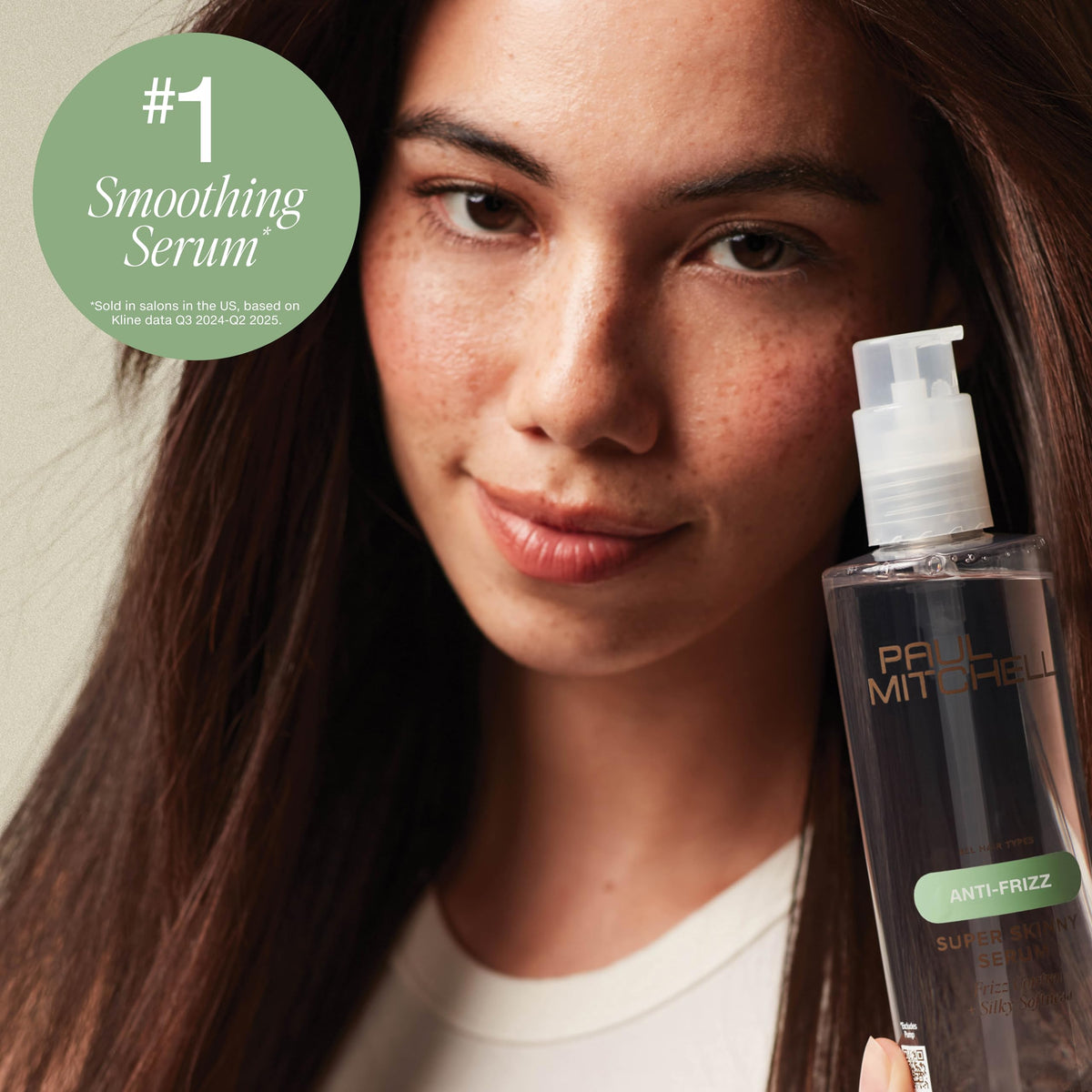 Applying Paul Mitchell serum to damp hair to speed drying and improve smoothness