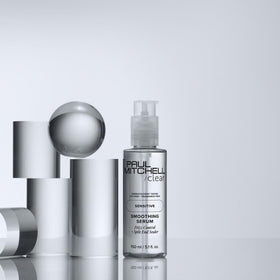 Paul Mitchell bottle beside hair dryer showing faster blow-dry performance