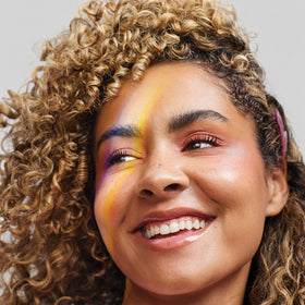 Paul Mitchell conditioner spread through damp textured hair for smoother finish