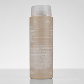 Paul Mitchell shampoo on shower shelf in bathroom lifestyle setting