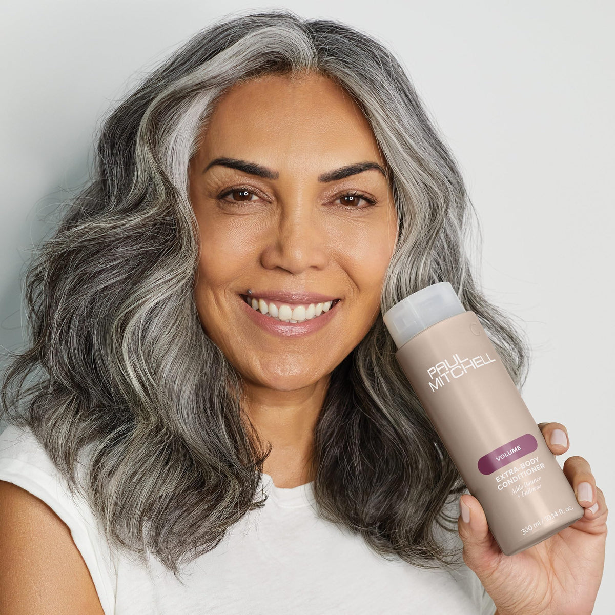 Paul Mitchell conditioner applied to wet hair in shower, showing detangling benefit