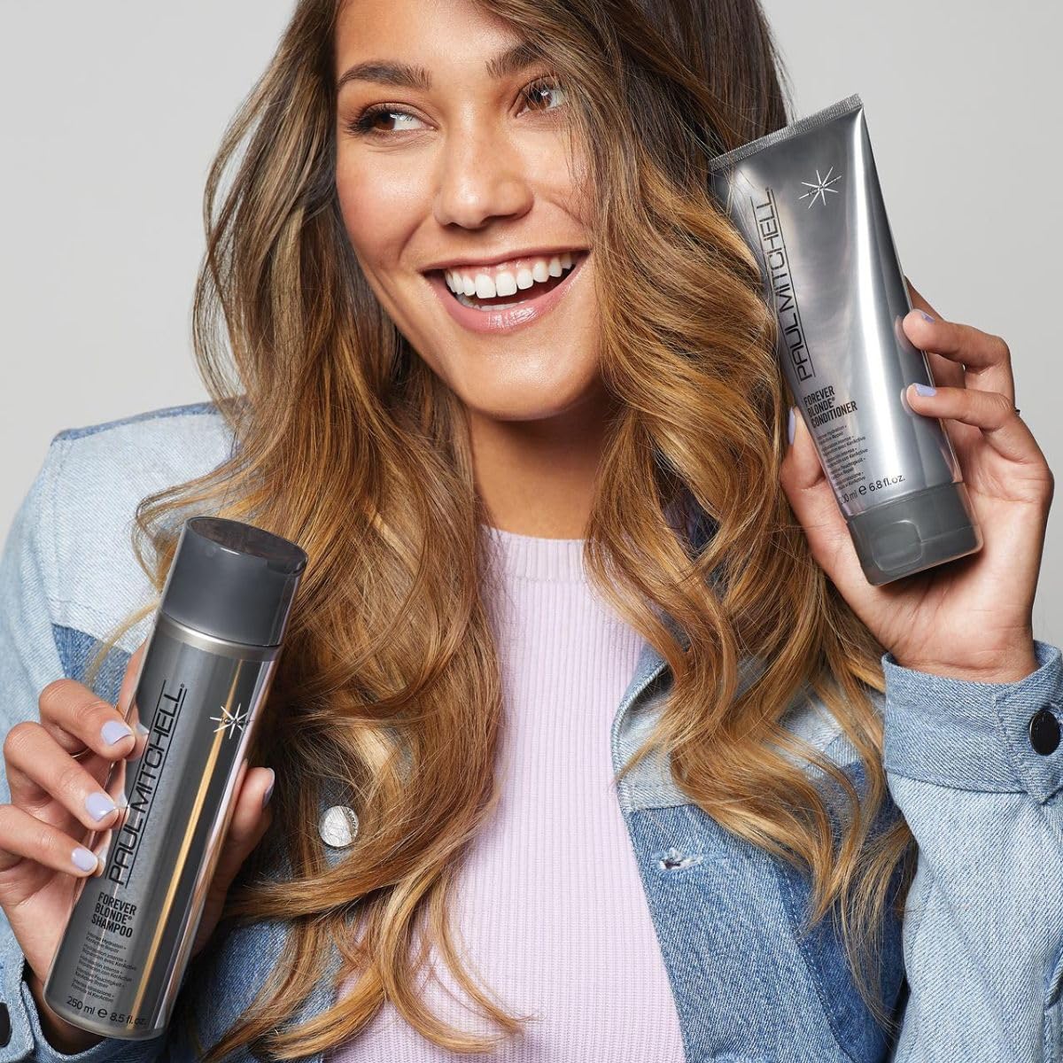 Paul Mitchell 24 fl oz bottle held to show size and salon-value benefit