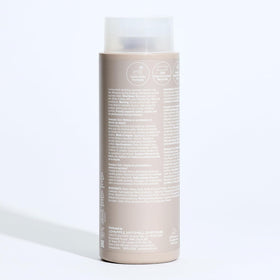 Paul Mitchell bottle in lemon-themed shower lifestyle showing fresh scent benefit