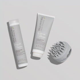Paul Mitchell bottle next to hand to show 33.8 fl oz scale benefit