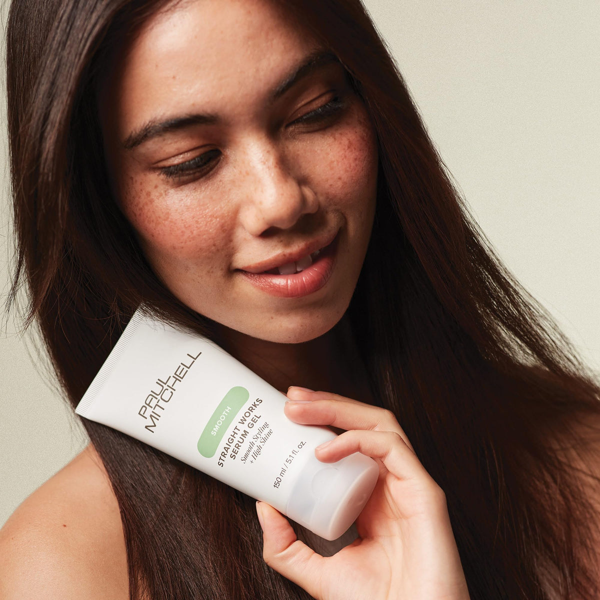 Paul Mitchell gel being applied to damp hair demonstrating even distribution and frizz control