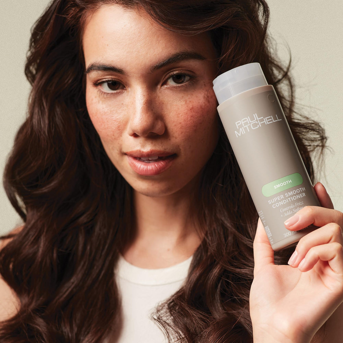Paul Mitchell conditioner applied in shower demonstrating easier detangling benefit
