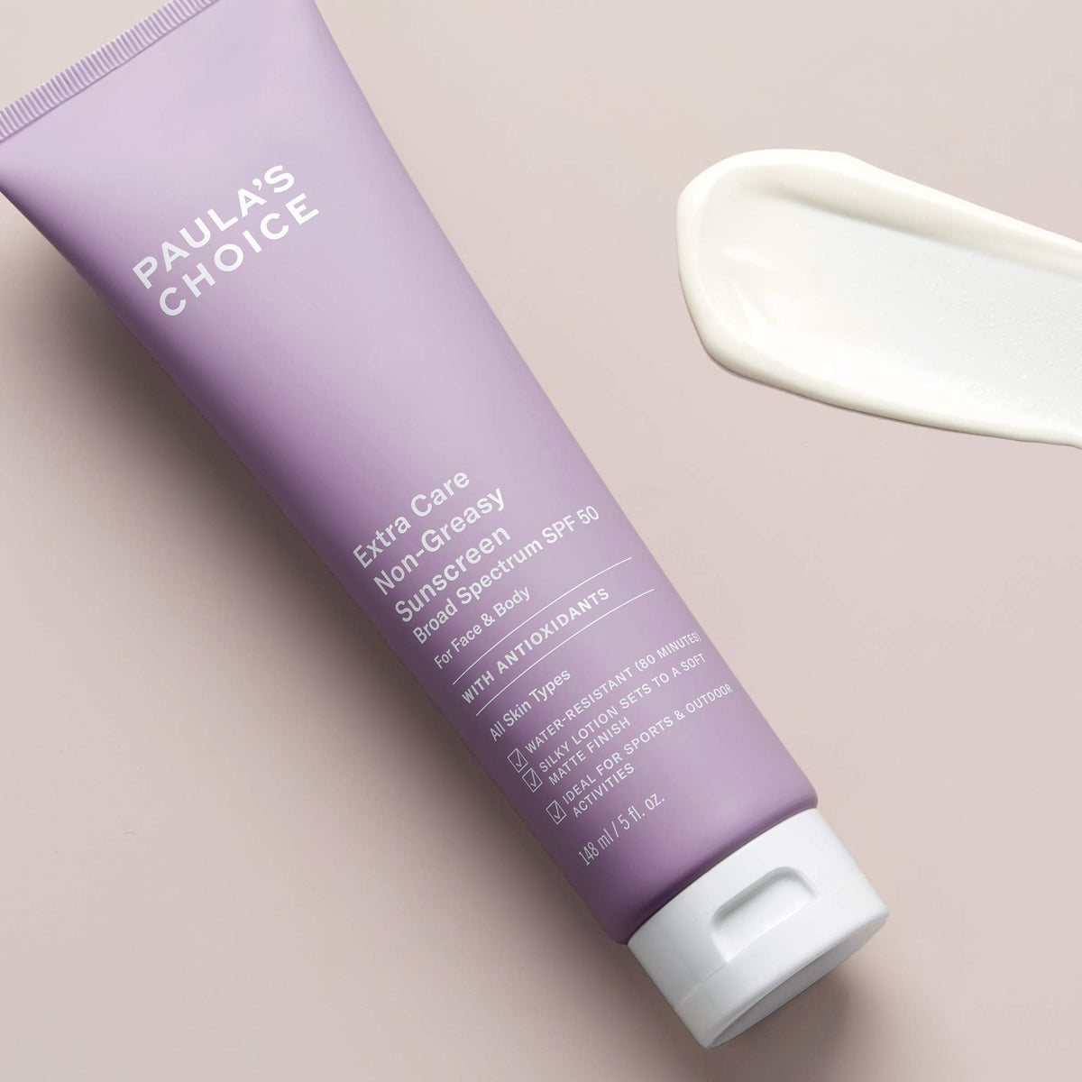 Paula's Choice 5oz lotion next to hand showing size and travel-friendly benefit