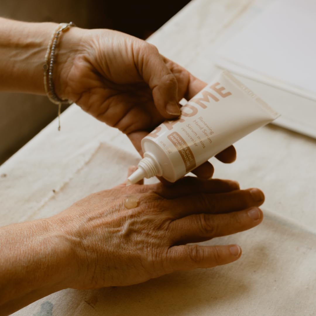 PAUME applying serum to hands showing smoother, more supple skin benefit