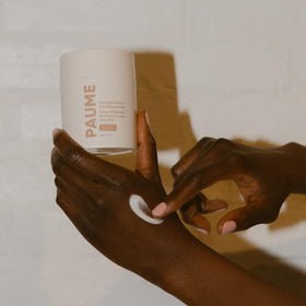 PAUME 3.4 oz tub beside everyday items showing compact travel-friendly benefit