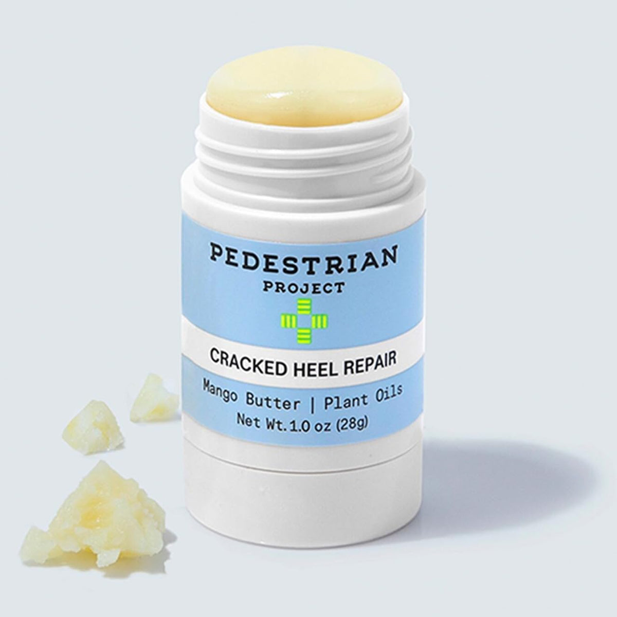 Pedestrian Project tube held in hand showing 1 oz travel-friendly benefit