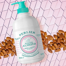 Perlier bottle beside bathtub in lifestyle setting conveying a relaxing almond-scented bath