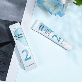 PERMANIA tube next to coin for scale illustrating compact 10 ml travel-friendly size