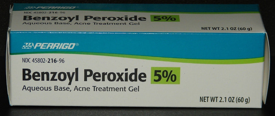 Perrigo 5% benzoyl peroxide tube front view showing label and compact size for travel
