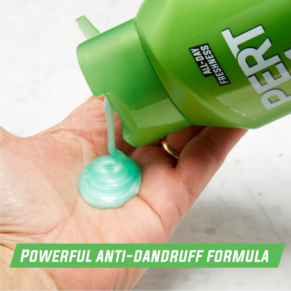 Pert in-shower use with hand applying product to hair demonstrating convenient 2-in-1 action
