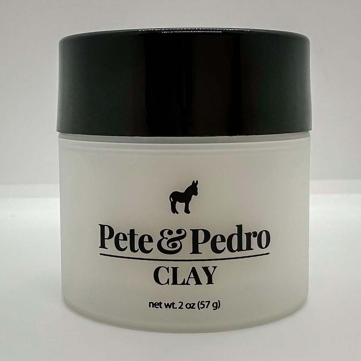 Pete & Pedro clay next to coin for scale showing the 2 oz travel-friendly size