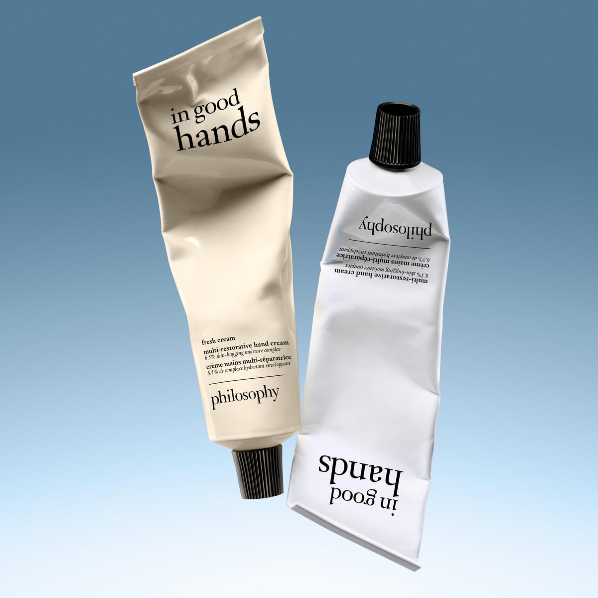philosophy hand cream on a desk near a laptop showing touchscreen-friendly benefit