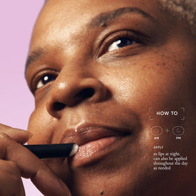 philosophy applying balm to lips demonstrating smoothing and priming