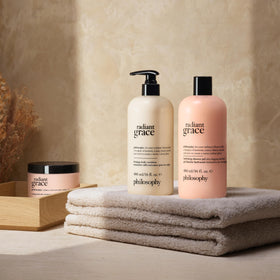 philosophy radiant grace on bathroom shelf staged with flowers benefit: luxurious daily ritual