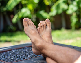 Phoenix Foot Peel lifestyle usage with man wearing booties at home