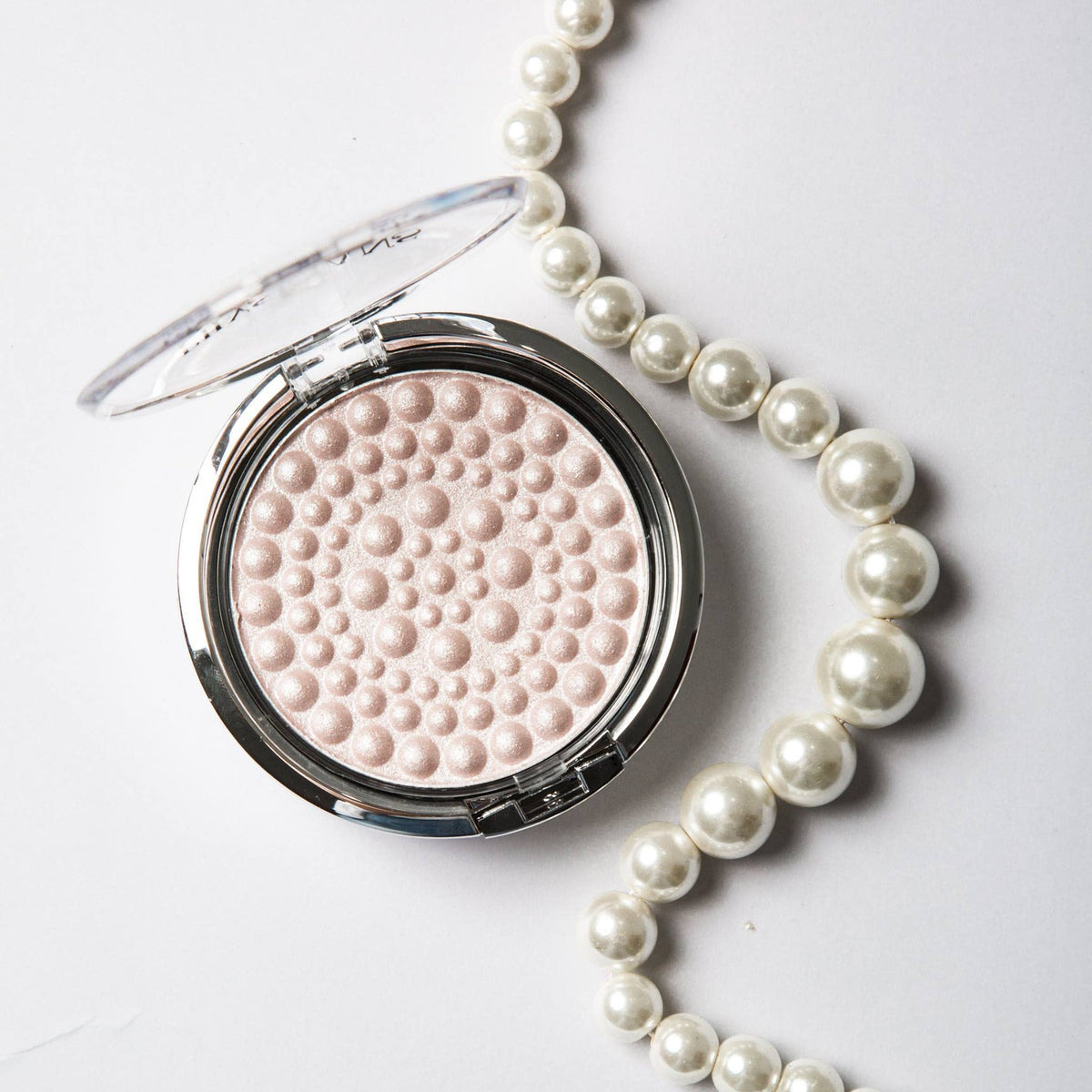 Physicians Formula brush applying pearls demonstrating easy blending and natural glow