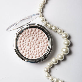 Physicians Formula brush applying pearls demonstrating easy blending and natural glow