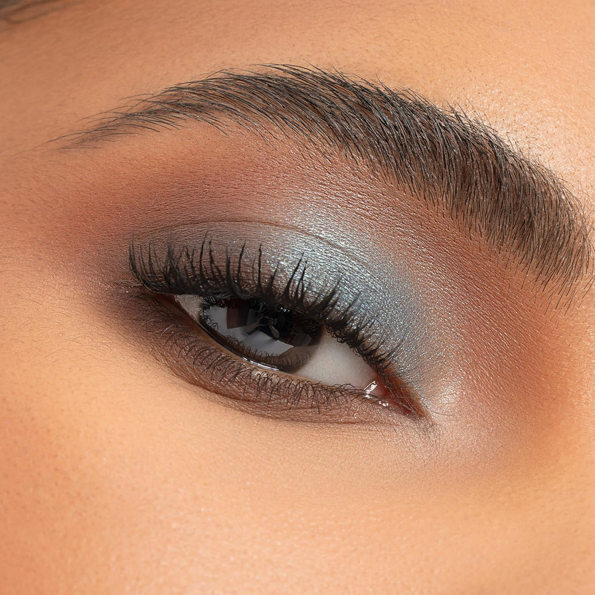 Physicians Formula palette with double-ended brush applying a shimmer shade precisely