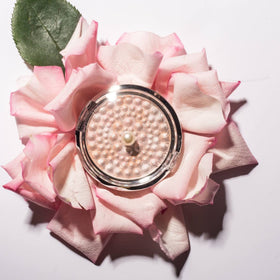 Physicians Formula compact inside a purse showing travel-ready makeup touch-up benefit