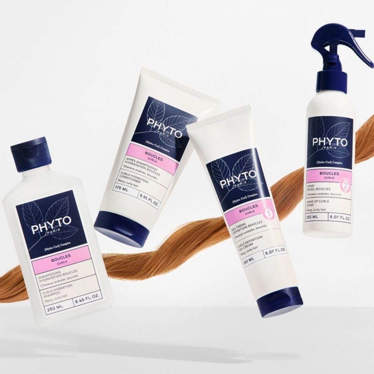 PHYTO conditioner being applied to hands before smoothing through hair