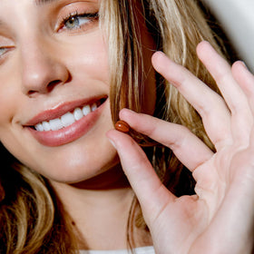 PHYTO capsules in hand to show scale, helps visualize serving size and portability
