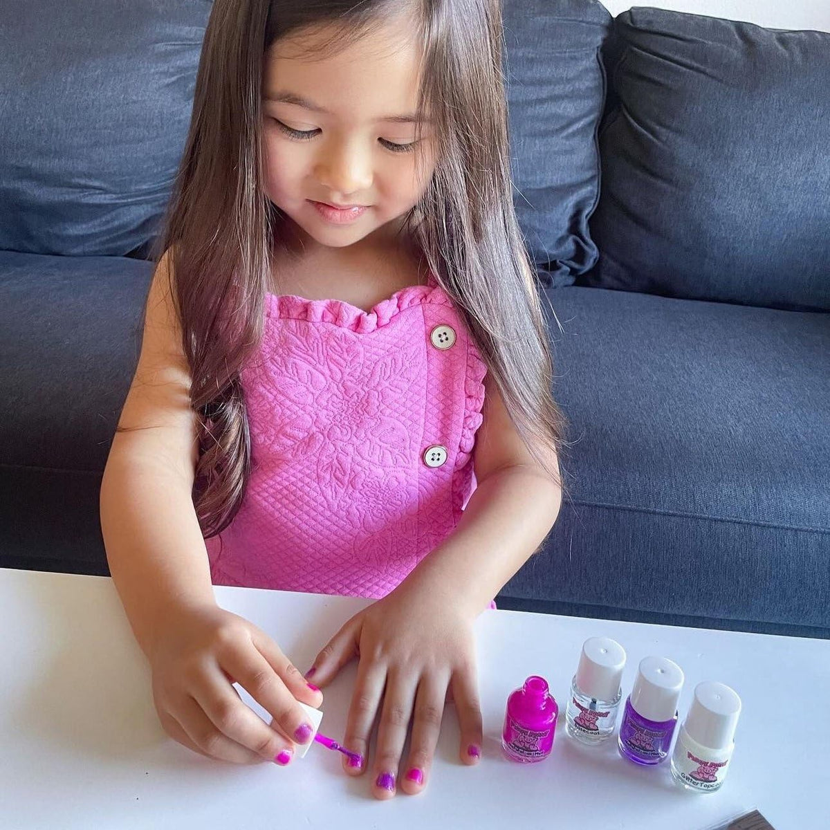 Piggy Paint applied on child's hands demonstrating low-odor, kid-friendly finish
