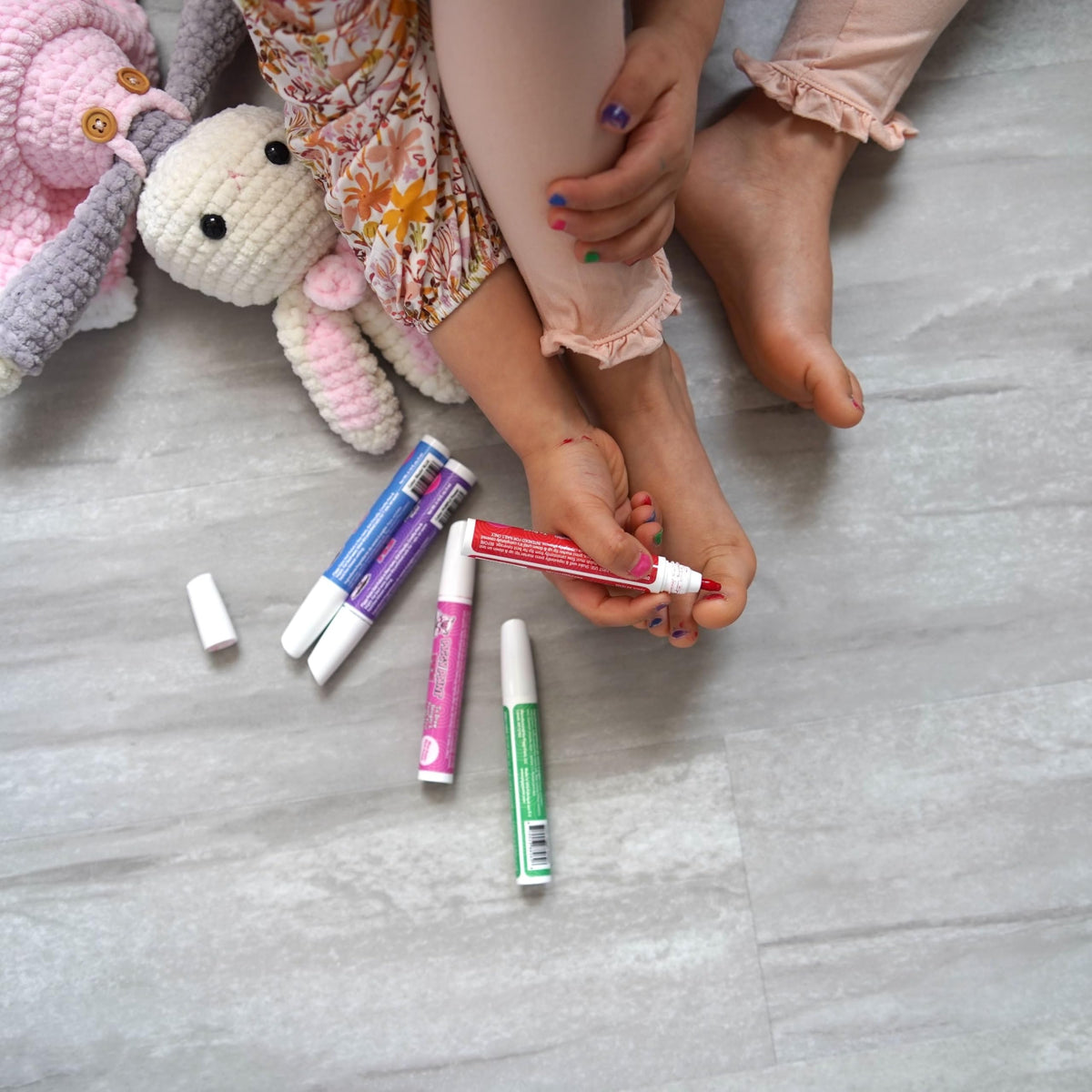 Child painting nails with Piggy Paint pens showing fun creative activity