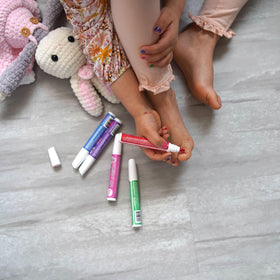 Child painting nails with Piggy Paint pens showing fun creative activity