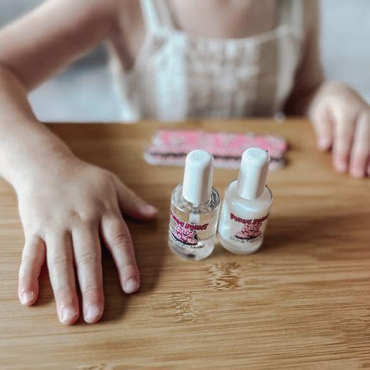 Piggy Paint bottles next to a coin showing scale and full-size 0.5 oz bottles
