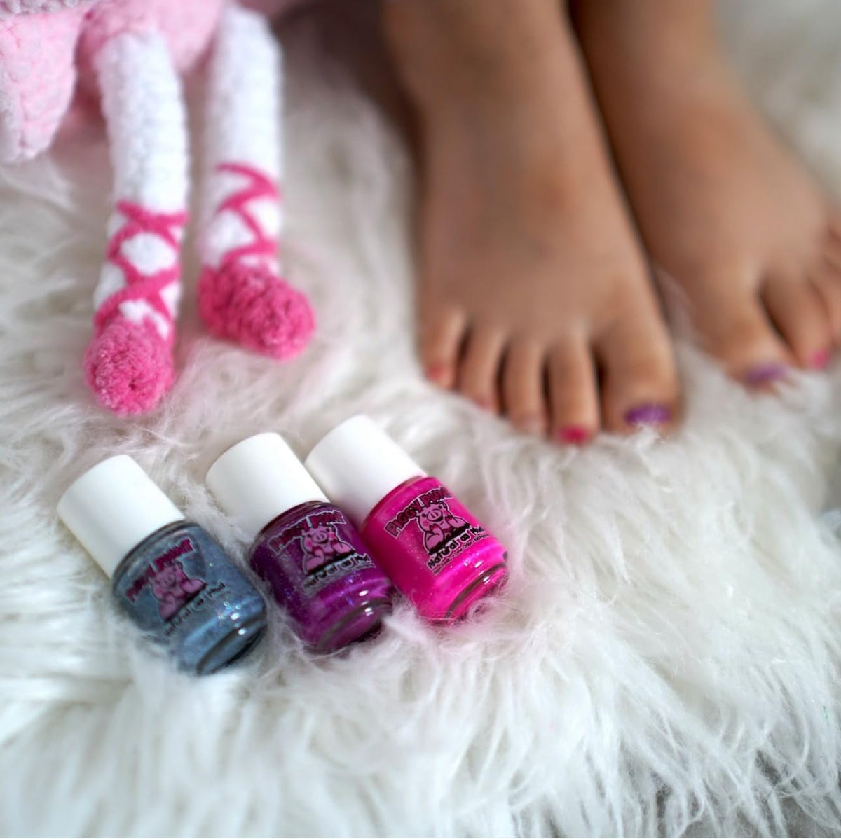 Piggy Paint mini bottle beside coin showing compact size and convenience