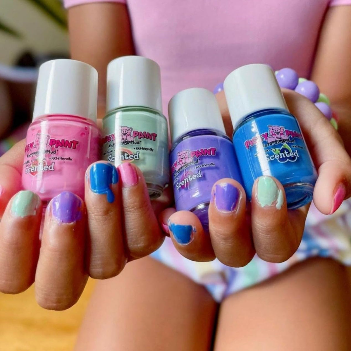 Piggy Paint child applying polish demonstrating safe, easy at-home use