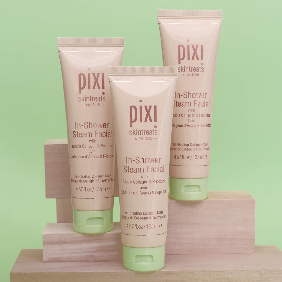 Pixi tube beside a hand for scale to show 135 ml size and travel suitability