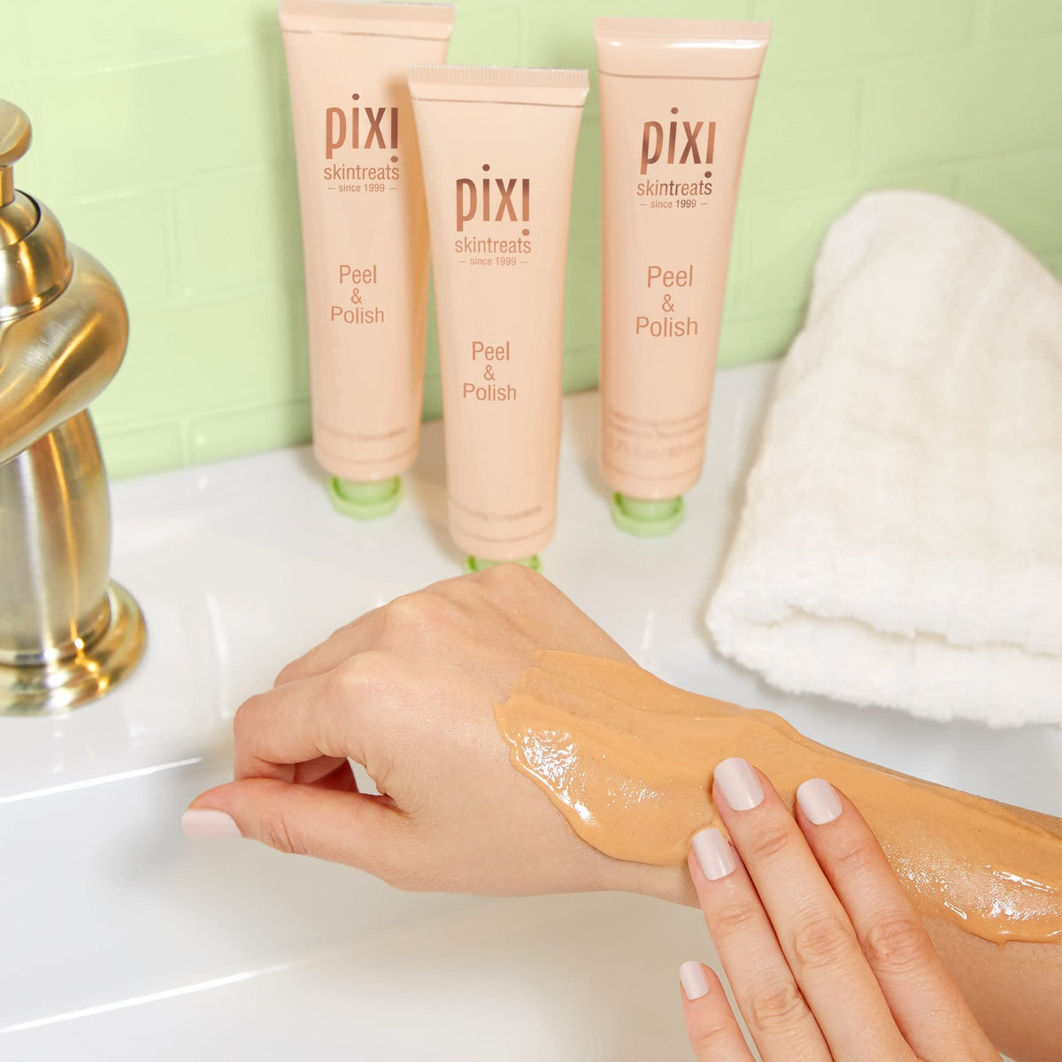 Pixi jar held in hand for size, illustrates portable 2.7 fl oz convenience