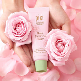 Pixi jar surrounded by rose petals emphasizing natural rose infusion and sensory appeal