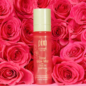 Pixi Rose Glow Mist next to passport illustrating travel-friendly size