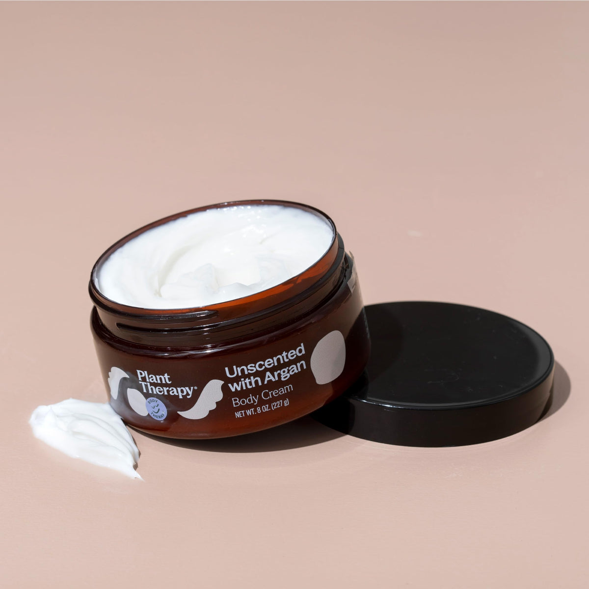 Plant Therapy cream on palm being applied to skin for instant softening