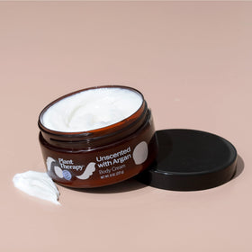 Plant Therapy cream on palm being applied to skin for instant softening