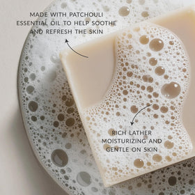 Plantlife patchouli soap stack showing scale beside hand for size and travel-friendly benefit