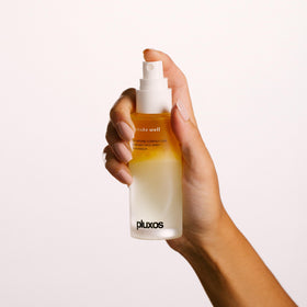 PLUXOS mist being sprayed onto face demonstrating quick reapplication benefit